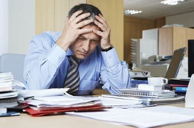 Frustrated businessman sitting at desk