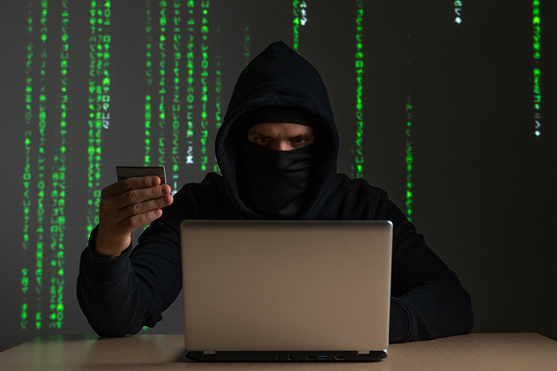copmuter hacker with credit card