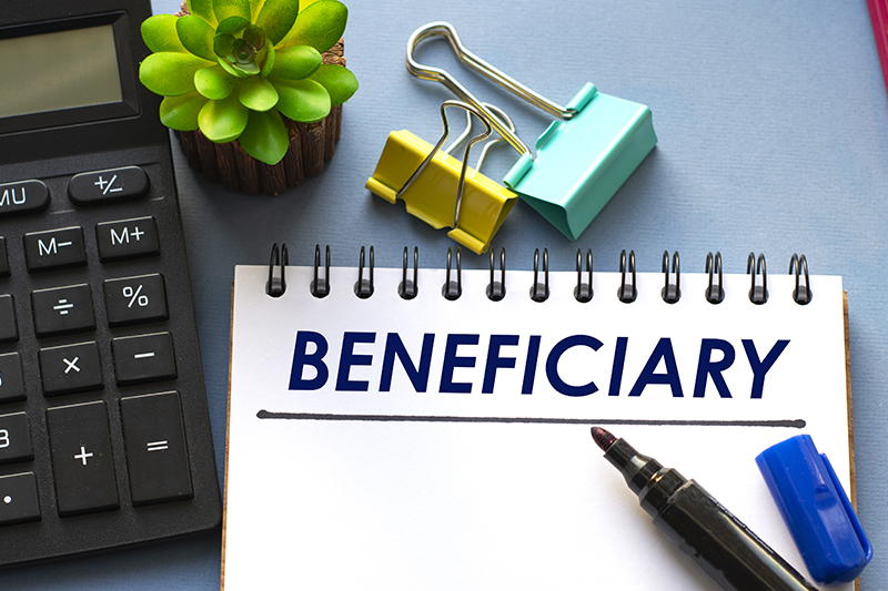 BENEFICIARY word is written in a notebook with a marker,